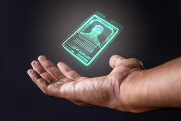 Closeup image of hand and digital identification card or digital ID on black background. Technology concept.