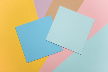 Square sheets of paper for origami creativity on a colored background
