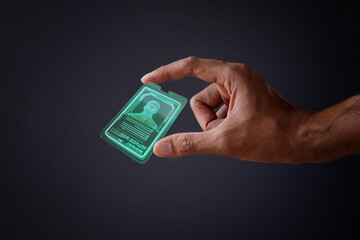 Closeup image of hand and digital identification card or digital ID on black background. Technology...