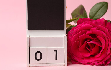 White Wooden calendar mockup with date 01 on pink background with flowers