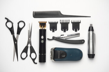 Trimmers, hair cutting scissors and razors, comb on a white background. Barber's working tools. Creative layout. Flat lay