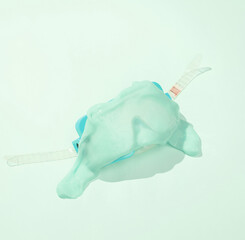 Creative minimalist layout. Diving mask with slime on blue background. Surreal summer idea. Conceptual pop