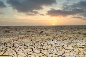 Cracked mudflats of the Waddensea by Westhoek, friesland, the Netherlands, tidal landscape like a...