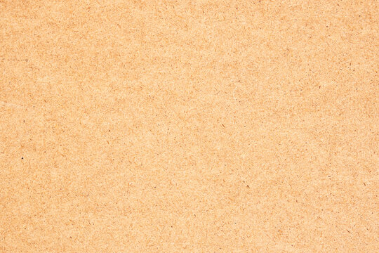 The texture of a material made from sawmill waste, pressed material from sawdust and paper. Reuse wood waste to create furniture.