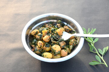 Aloo Methi or Fenugreek potato vegetable. It is made with fresh fenugreek leaves and potatoes. Indian homemade traditional Aalu Methi dry curry. Fenugreek potato sabzi  is healthy Indian Cuisine.
