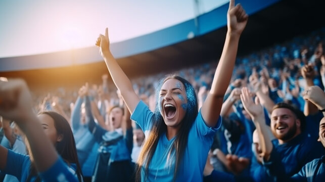 group of fans dressed in blue color watching a sports event in the stands of a stadium - Powered by Adobe