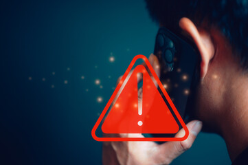 man holding mobile phone with alert warning red triangle sign showing to be careful with fraudulent...