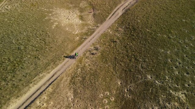 Extreme motorcycle riding from a height. Aerial photography of a motorcyclist on a mountain bike.