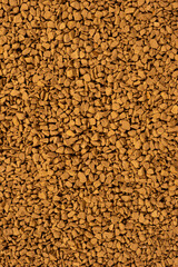 Background of freeze-dried granulated instant coffee macro close-up.