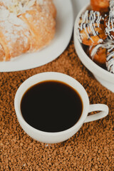 Delicious breakfast - cup of instant coffee, croissant.