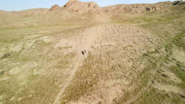 Extreme motorcycle riding from a height. Aerial photography of a motorcyclist on a mountain bike.