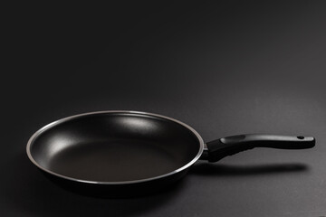 Black fry pan on dark background. close up
