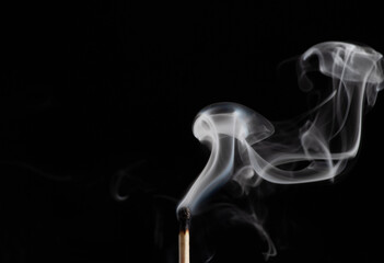 Smoke from a match that was just put out, isolated on black background