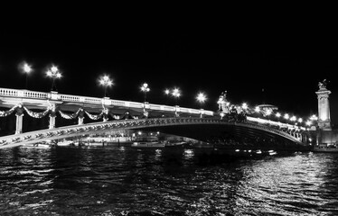 A black and white photo of the river Seine and a bridge, in Paris, France