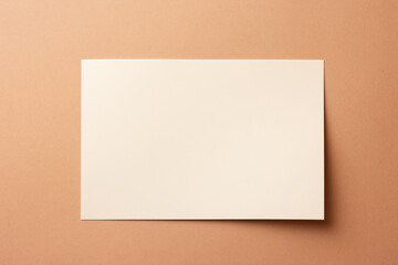Empty piece of paper on a beige background, note mockup