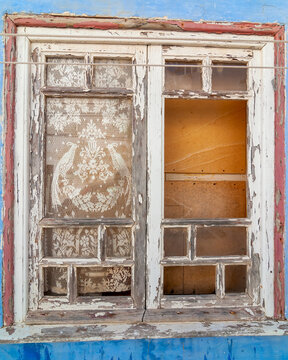 Closeup of an old, wooden window with faded paint