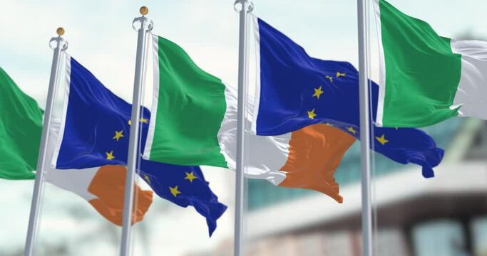 Flags of Ireland and the European Union waving on a clear day