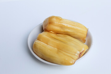 Yellow Jackfruit flesh from Artocarpus heterophyllus, on small white plate, isolated on white background