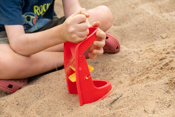 Child’s Play with a Red Sand Toy