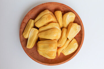 Yellow Jackfruit flesh from Artocarpus heterophyllus, on wooden plate, isolated on white background, flat lay or top view