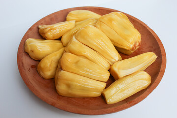 Yellow Jackfruit flesh from Artocarpus heterophyllus, on wooden plate, isolated on white background
