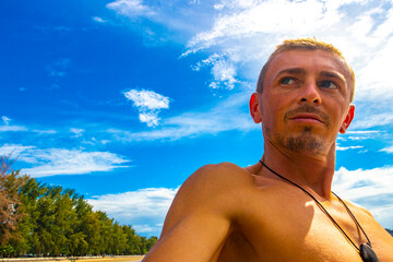 Man takes selfie photo tropical paradise beach Ao Nang Krabi Thailand.