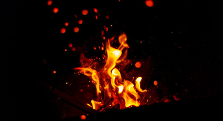 Fototapeta na wymiar Fire with sparks at night. Bonfire