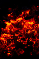 Fototapeta na wymiar Burning coals in the night. Extinguished fire