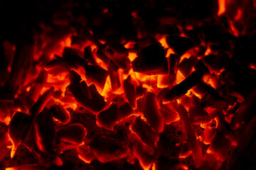 Smoldering fire with coals. Coals burn in the night