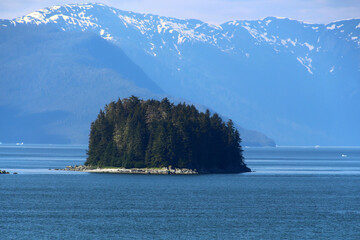 Alaska, small tree covered island in the Sitka Sound a body of water near the city of Sitka,...
