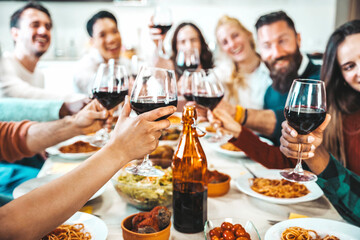 Happy friends toasting red wine glasses at dinner party - Group of people having lunch break at bar restaurant - Life style concept with guys and girls hanging out together - Food and beverage - obrazy, fototapety, plakaty