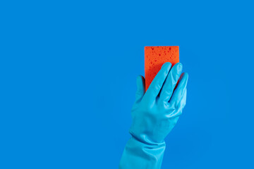 Hygiene and cleanliness, hand using cleaning sponge, professional service,blue background