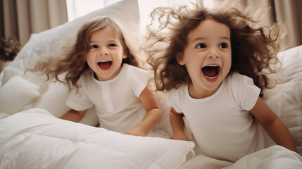 Two little children on the bed having fun Playing down pillow fights - obrazy, fototapety, plakaty