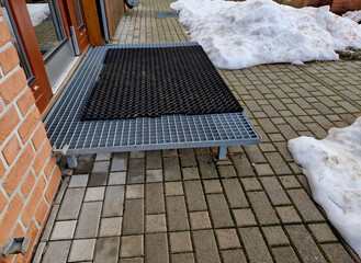 staircases made of steel gratings with rubber anti-slip mats. the mat at the cottage is on a raised...