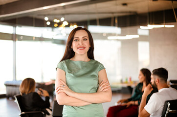 Female leader with employees in office