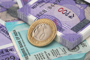 Indian coin on currency note background.