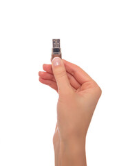 A woman's hand holds a flash drive. Isolated on a white background.