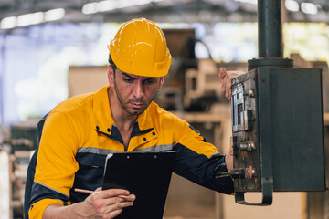 Caucasian engineer using a laptop in a factory. man working in plastics factory.