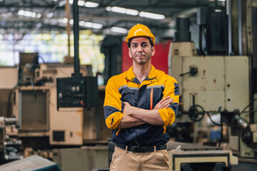 Caucasian engineer using a laptop in a factory. man working in plastics factory.