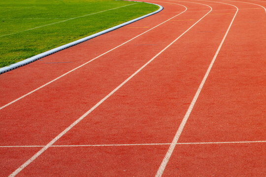 Red athletic  running track in stadium. Rubber coating.