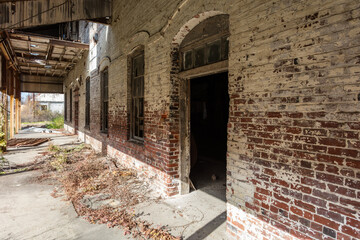 Beautiful brick warehouse sitting abandoned in urban Jackson Mississippi - 703357679