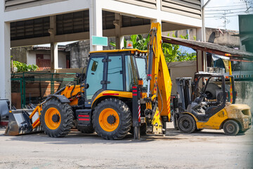 Yellow used excavators maneuverable loader stand in street city