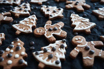 Gingerbread with white icing on a dark background