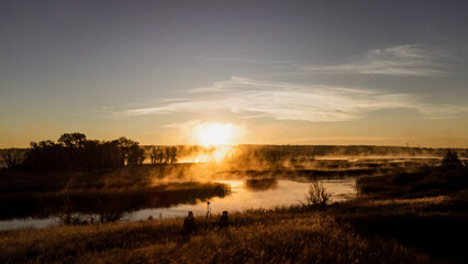 Colorful fog over the lake in autumn at dawn