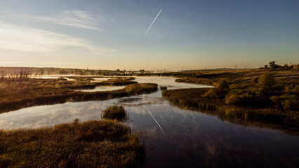 Colorful fog over the lake in autumn at dawn