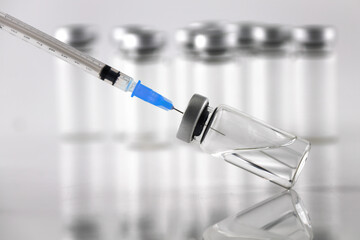 Syringe and ampule bottles for vaccination on white background