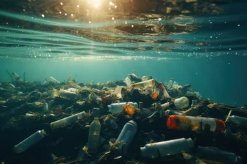 Wandcirkels aluminium plastic debris in the ocean background. Underwater image illustrating problem of microplastics pollution in environment © Dina
