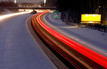 Long exposure tail lights on highway in winter time