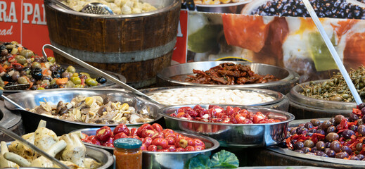 Food stall at a market in Catania, Sicily. Tomatoes, olives, spring onions and other delicacies