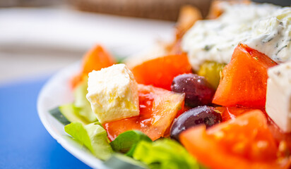 Greek salad with fresh vegetables, feta cheese, tomatoes and olives. Healthy food.